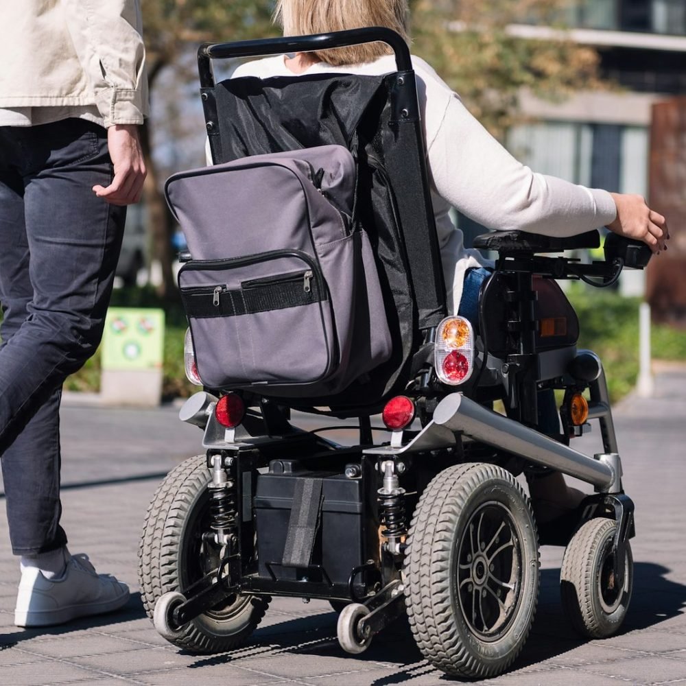 woman using wheelchair with a man taking a walk